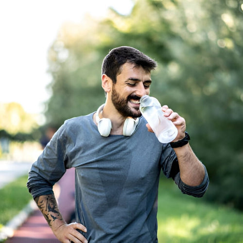 Man done running drinking from water bottle
