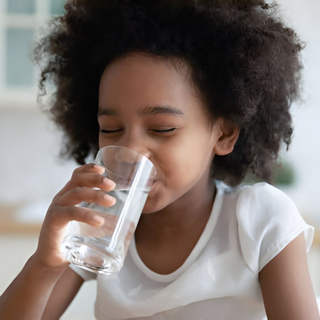 African American Girl Eyes Closed While Drinking Water