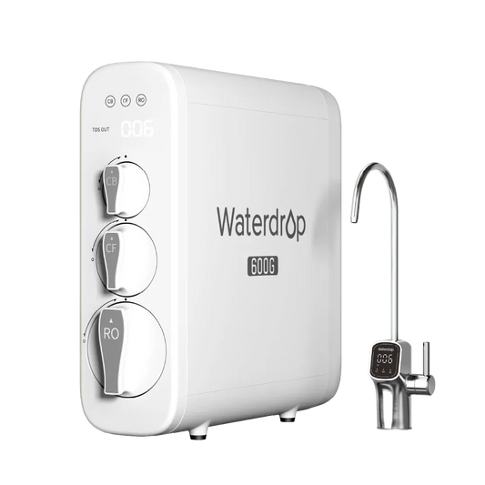 White rectangular Waterdrop 600G plastic water filter with three round dials and a metal faucet on a black background.